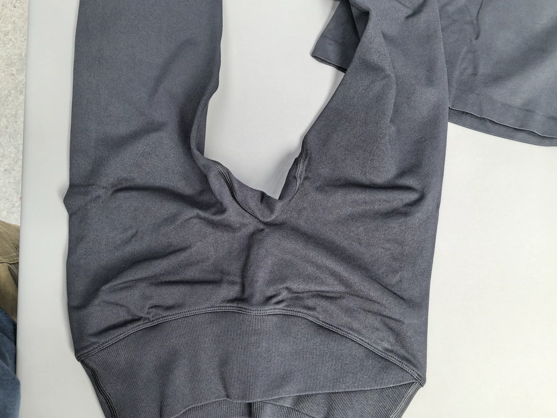 Flat-lay of the leggings, front view, showing the crotch curve and the placement of the gusset